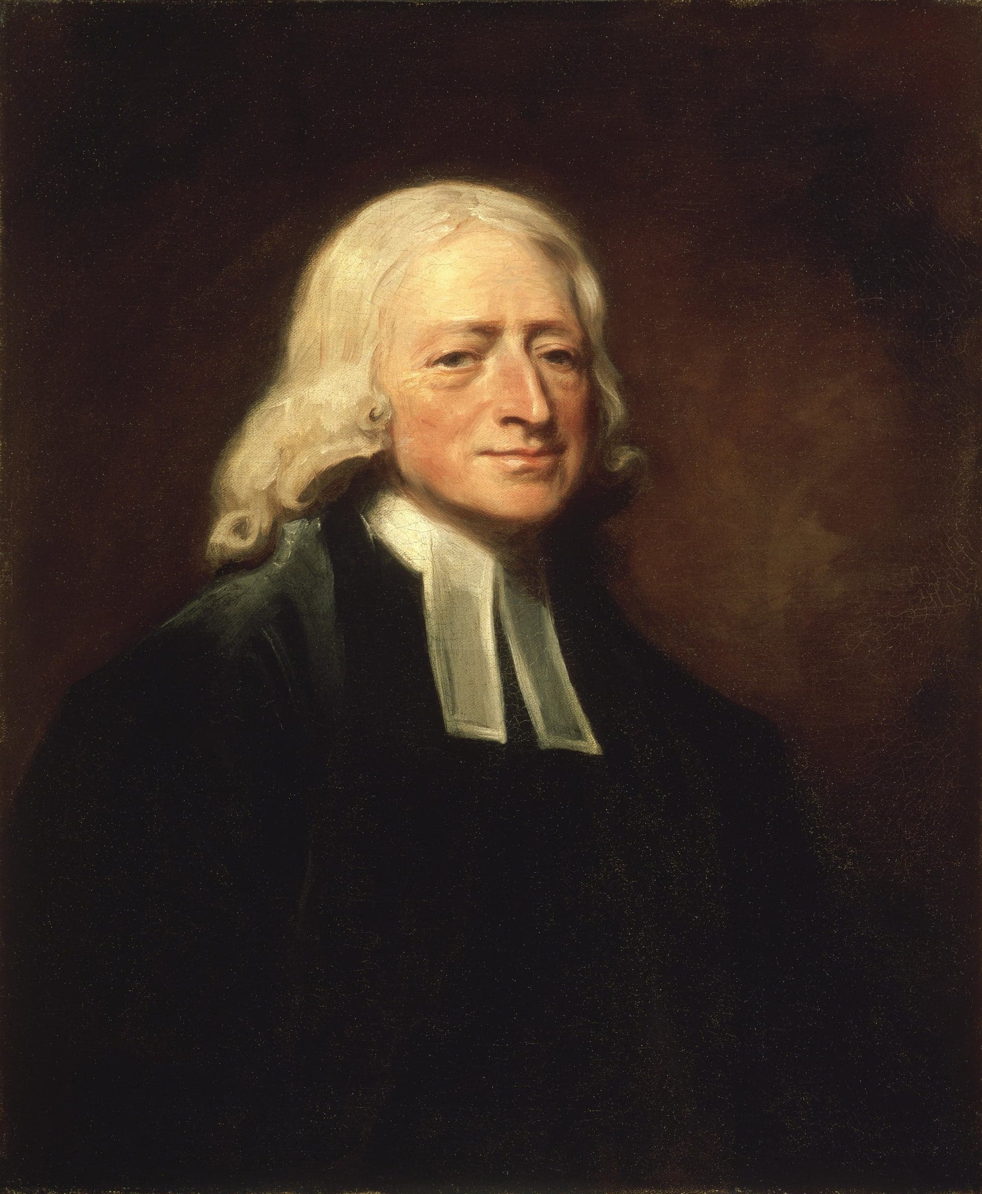 John Wesley in old age, in a black gown and white bands, with long white hair, turned slightly to his left against a dark ground.
