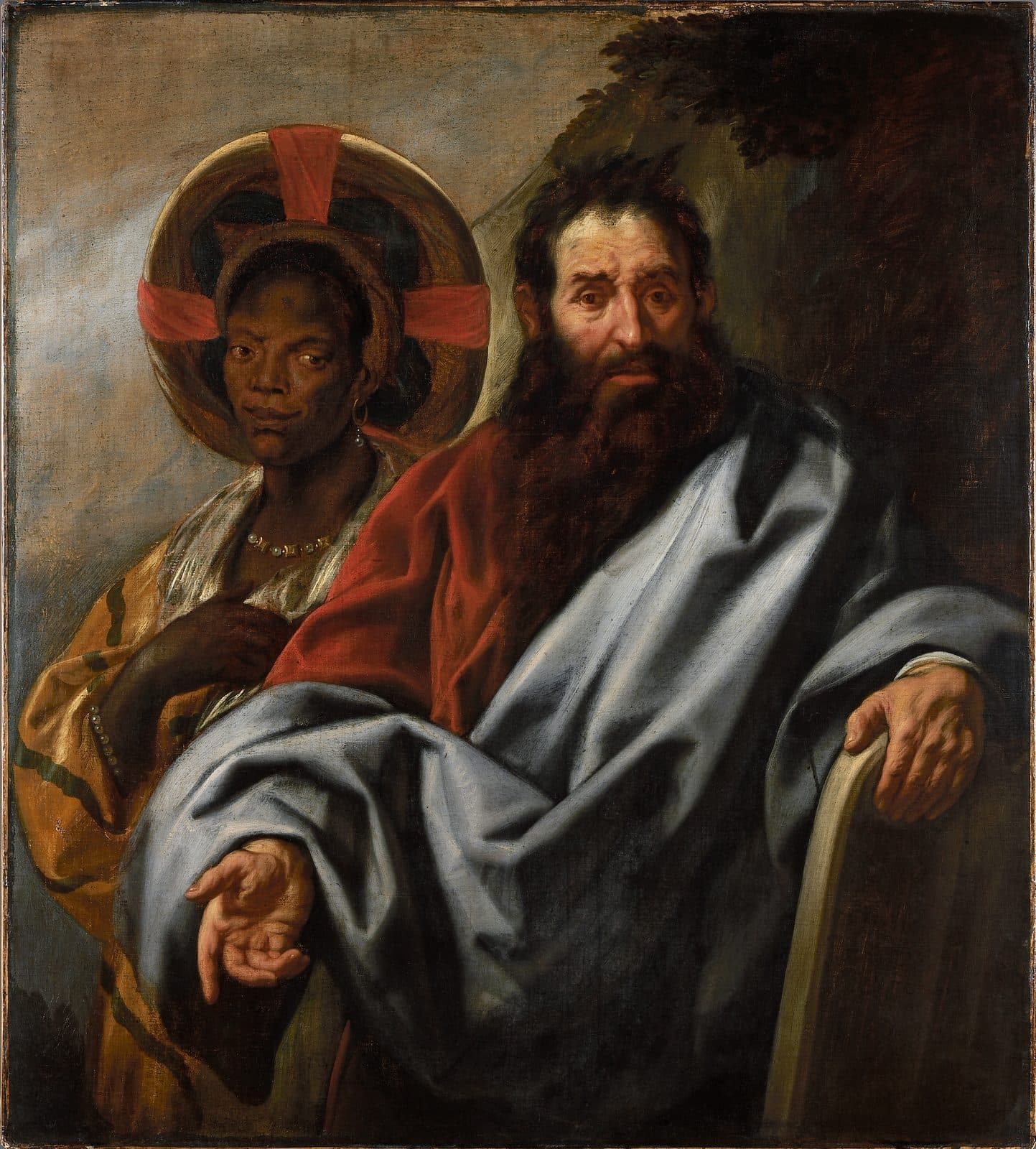 A half-length painting of Moses with a long dark beard, in a red robe under a blue-grey mantle, one hand resting on a stone tablet and the other held open, and behind his shoulder an African woman in a round red and gold headdress, a pearl necklace and a striped gold robe, her hand at her breast.