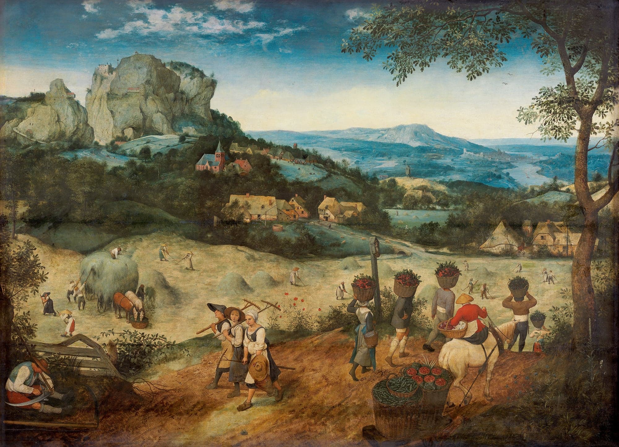 A wide summer landscape of hay meadows below a rocky hill with a castle, a village church and a river valley. In the foreground three peasants walk with rakes over their shoulders, a man sharpens his scythe, and others carry baskets of fruit and vegetables on their heads. Farther off, workers mow, rake and load hay onto a horse-drawn cart.