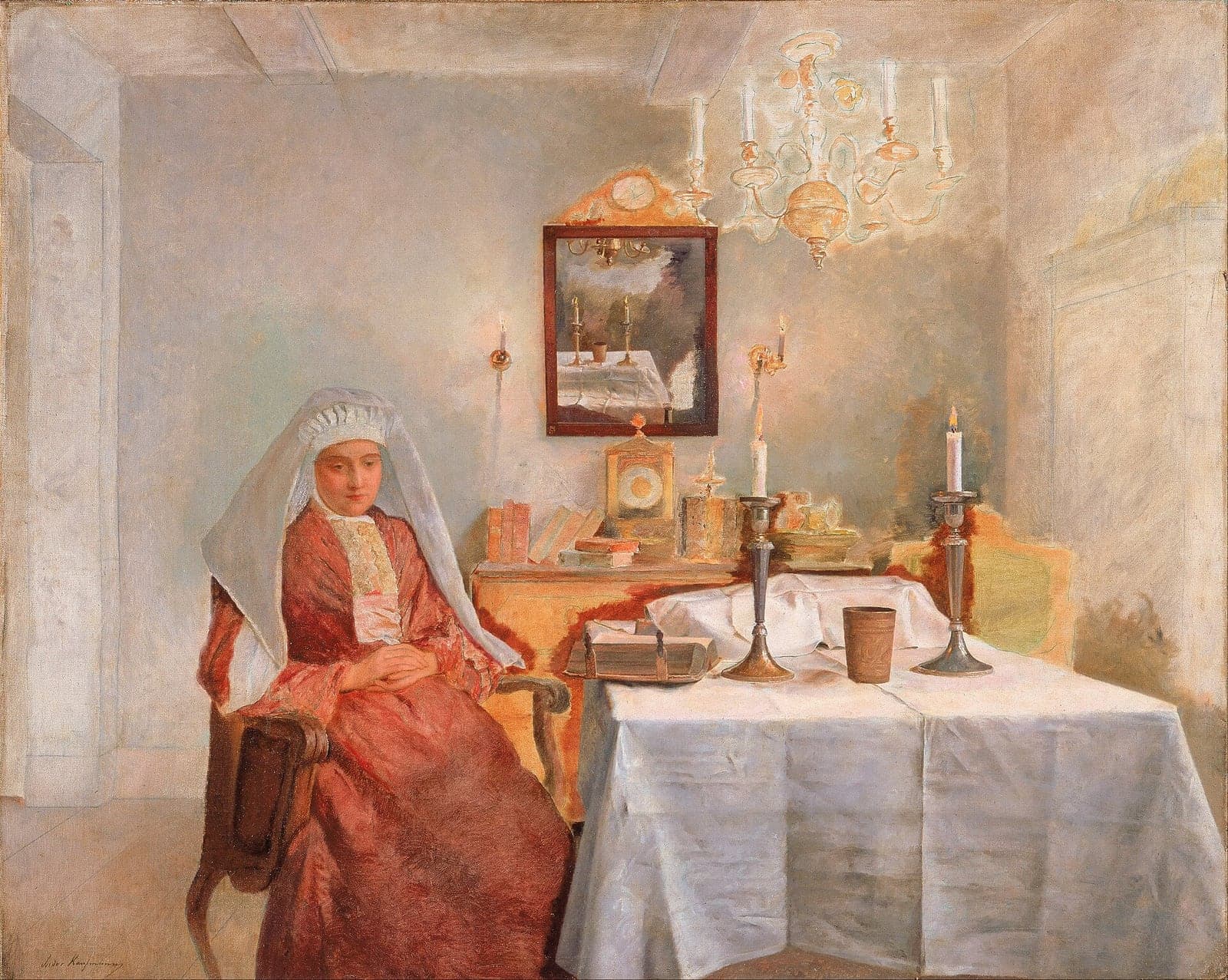 A woman in a red dress and a white lace head covering sits in a wooden armchair beside a table laid with a white cloth, two lit candles in tall silver candlesticks and a cup, with a mirror, a clock, books and an unlit chandelier in the pale room behind her.