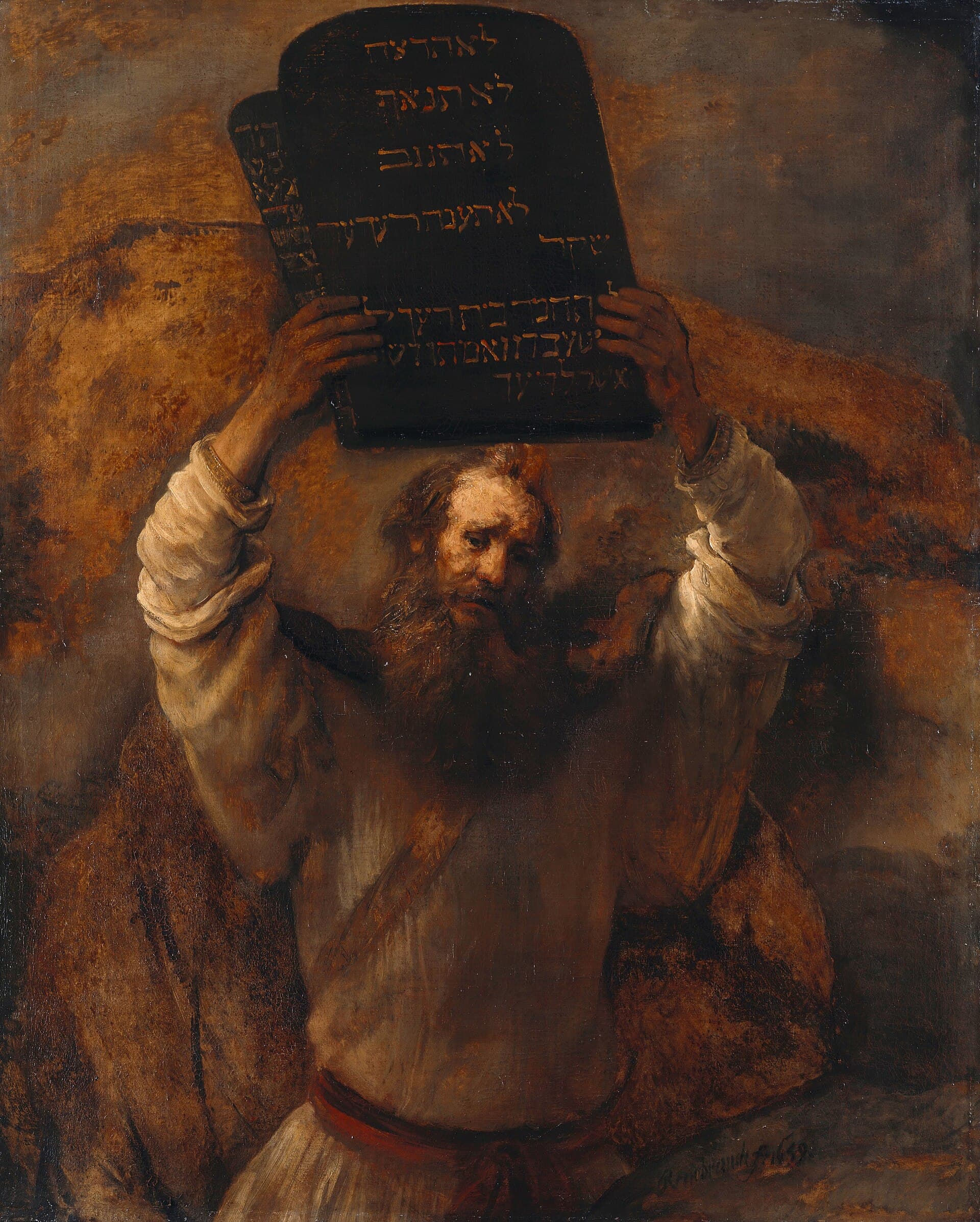 Moses holds the two stone tablets above his head, his face lit from below