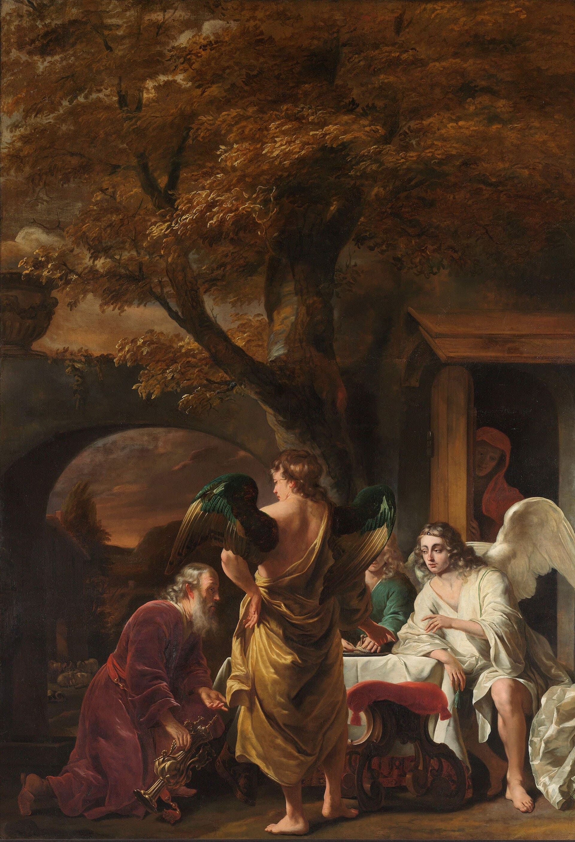 An old man in a red robe kneels with a golden jug before three young men at a table, two of them winged, under a great oak. A woman in a red hood watches from the doorway of a house at right.