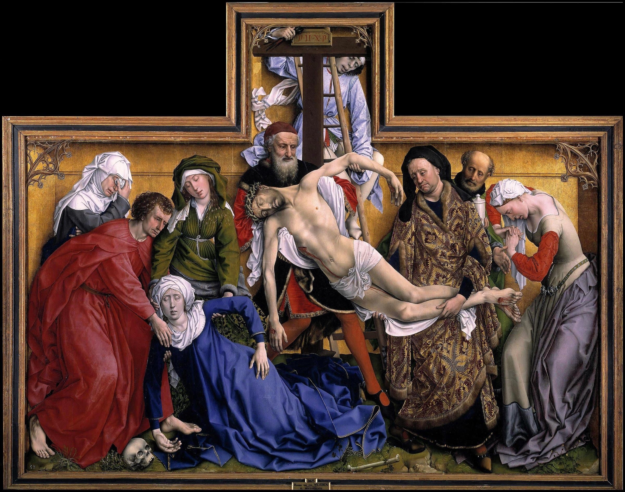 On a gold ground inside a carved frame shaped like a cross, a man on a ladder and two older men lower the pale body of Jesus from the cross. Mary, in a blue robe, has fainted beside the body and is held by John in red and a woman in green; weeping women stand at the left and right, and a skull and a bone lie on the grass at the foot.
