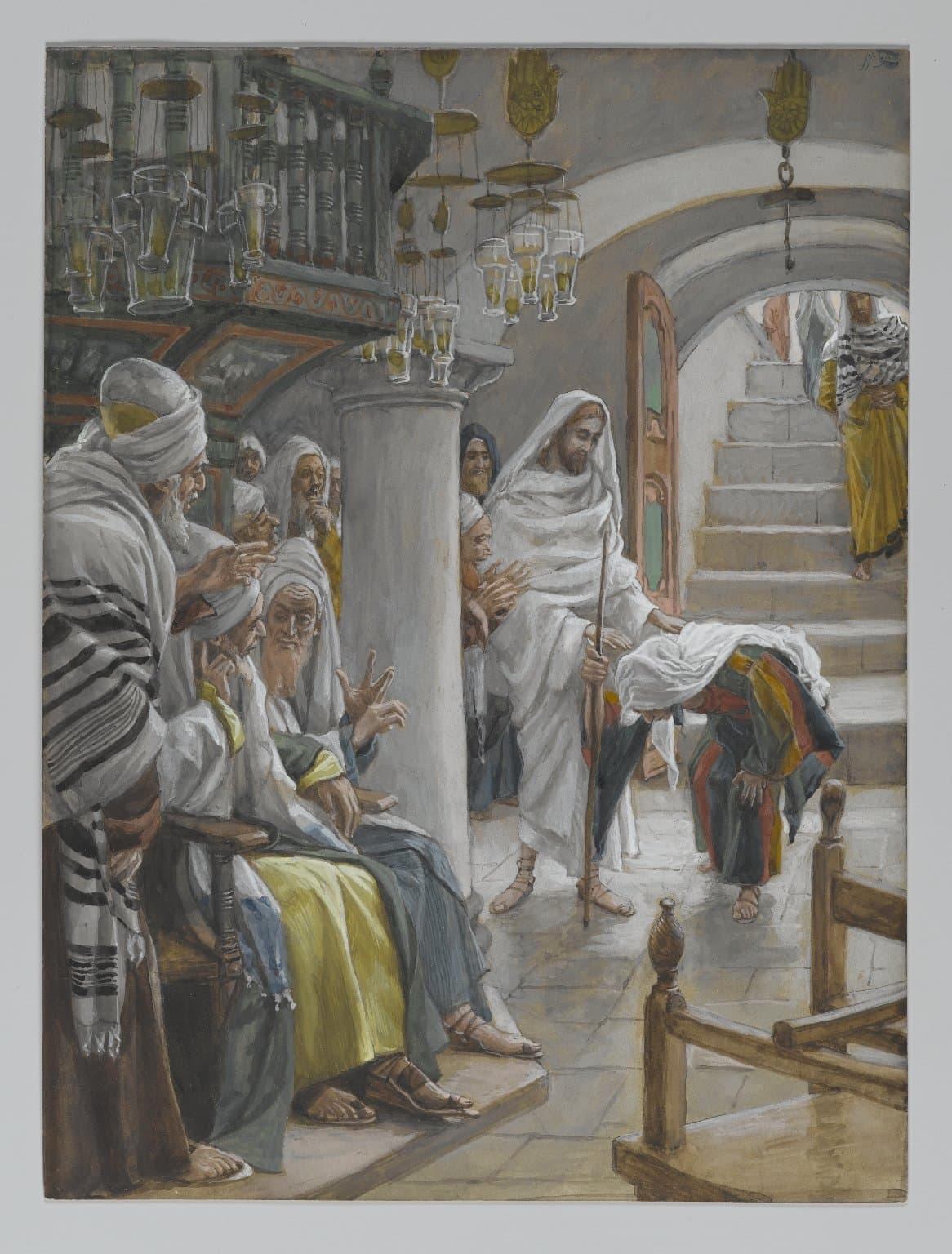 In a synagogue hung with lamps, Jesus in a white robe with a staff lays His hand on the back of a bent woman in a striped cloak, while elders in prayer shawls sit on a bench at the left and raise their hands in protest.