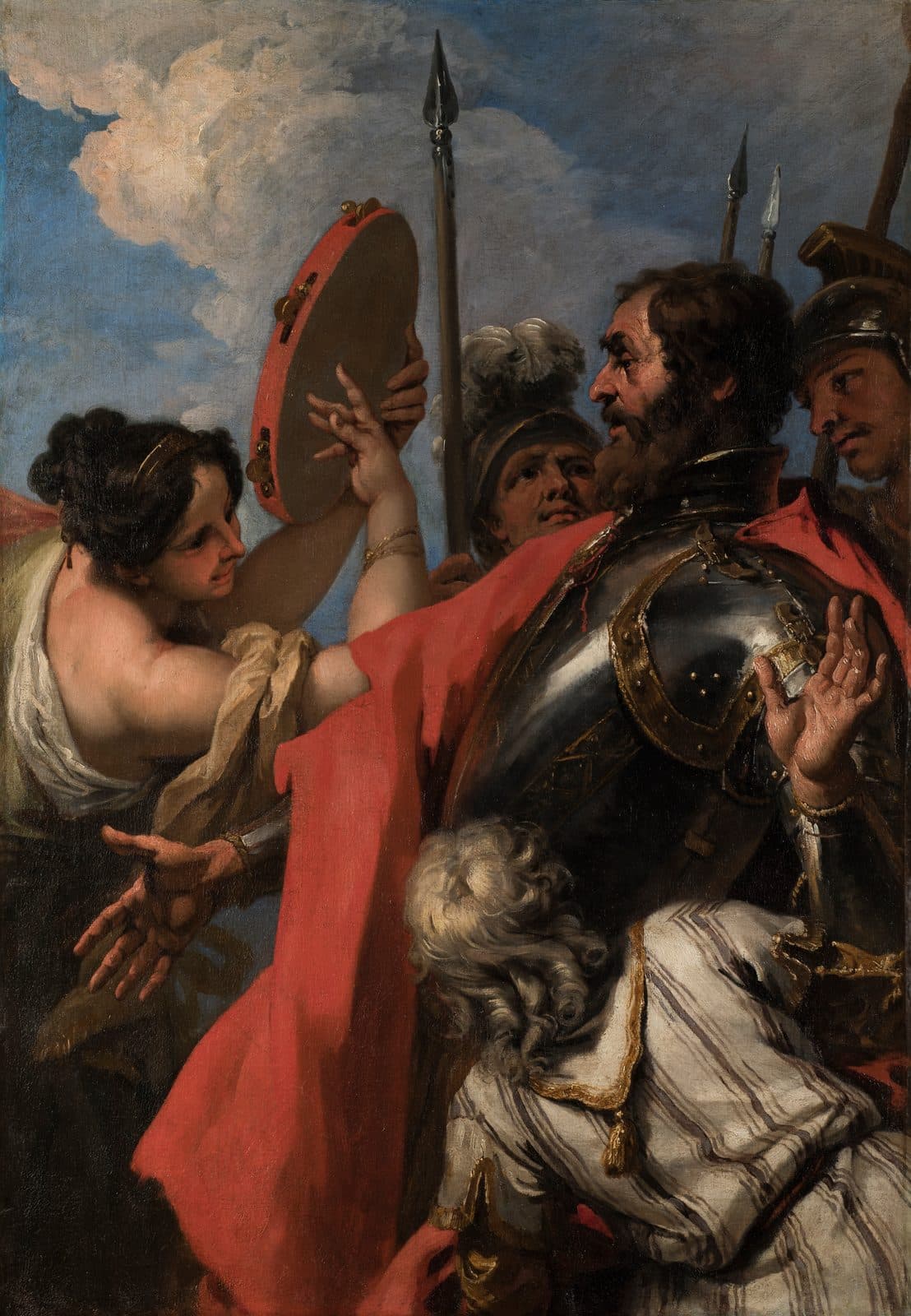 A young woman in a pale gown lifts a red tambourine and reaches toward a bearded commander in black armour and a red cloak, who draws back with one hand raised, while helmeted soldiers with spears stand behind him and a grey-haired man in a striped robe stands with his back to the viewer.