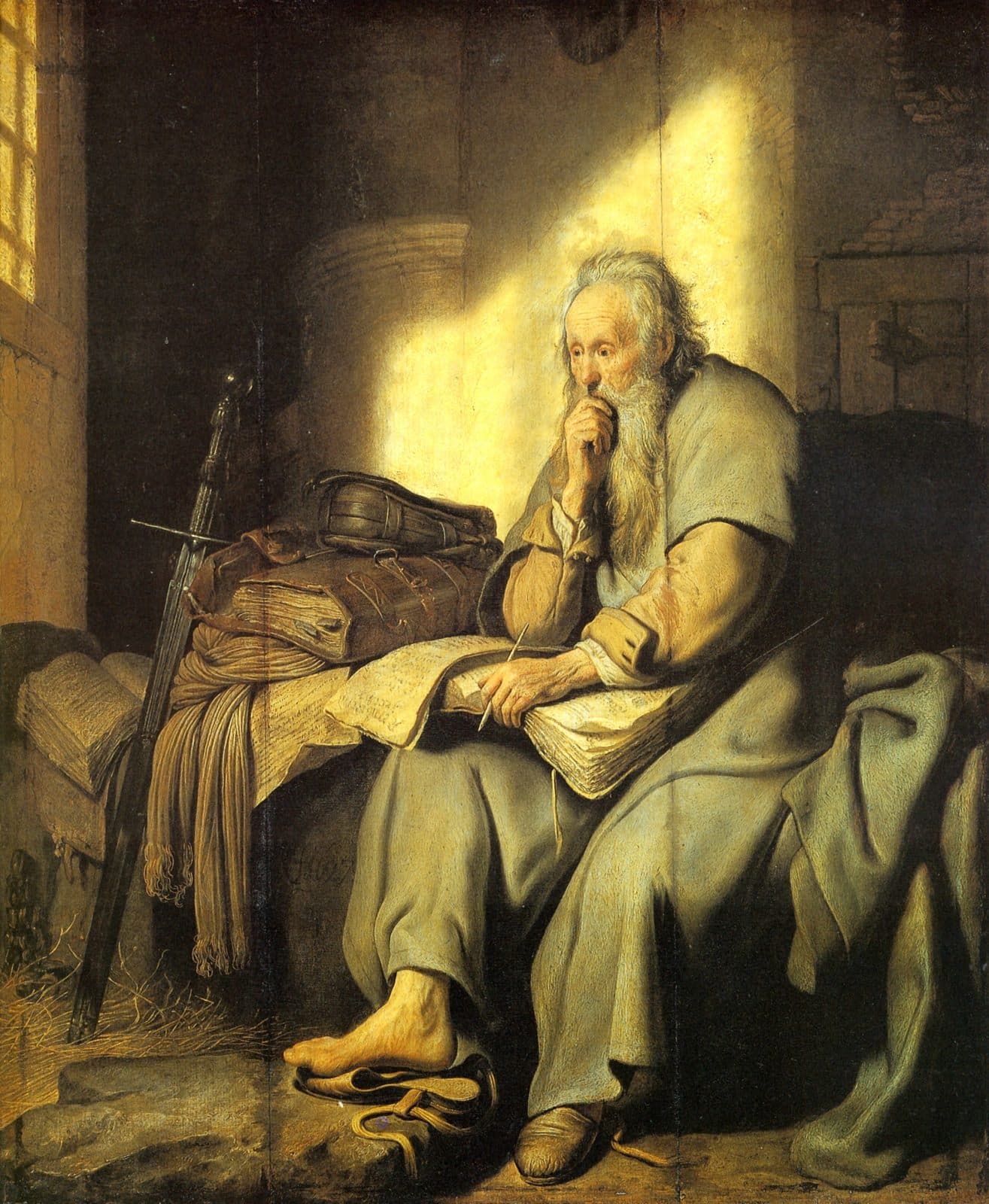 An old man in a grey robe sits on a prison bed with a book open on his knee and a pen in his hand. A sword and a leather bag lie beside him, and light falls from a barred window.