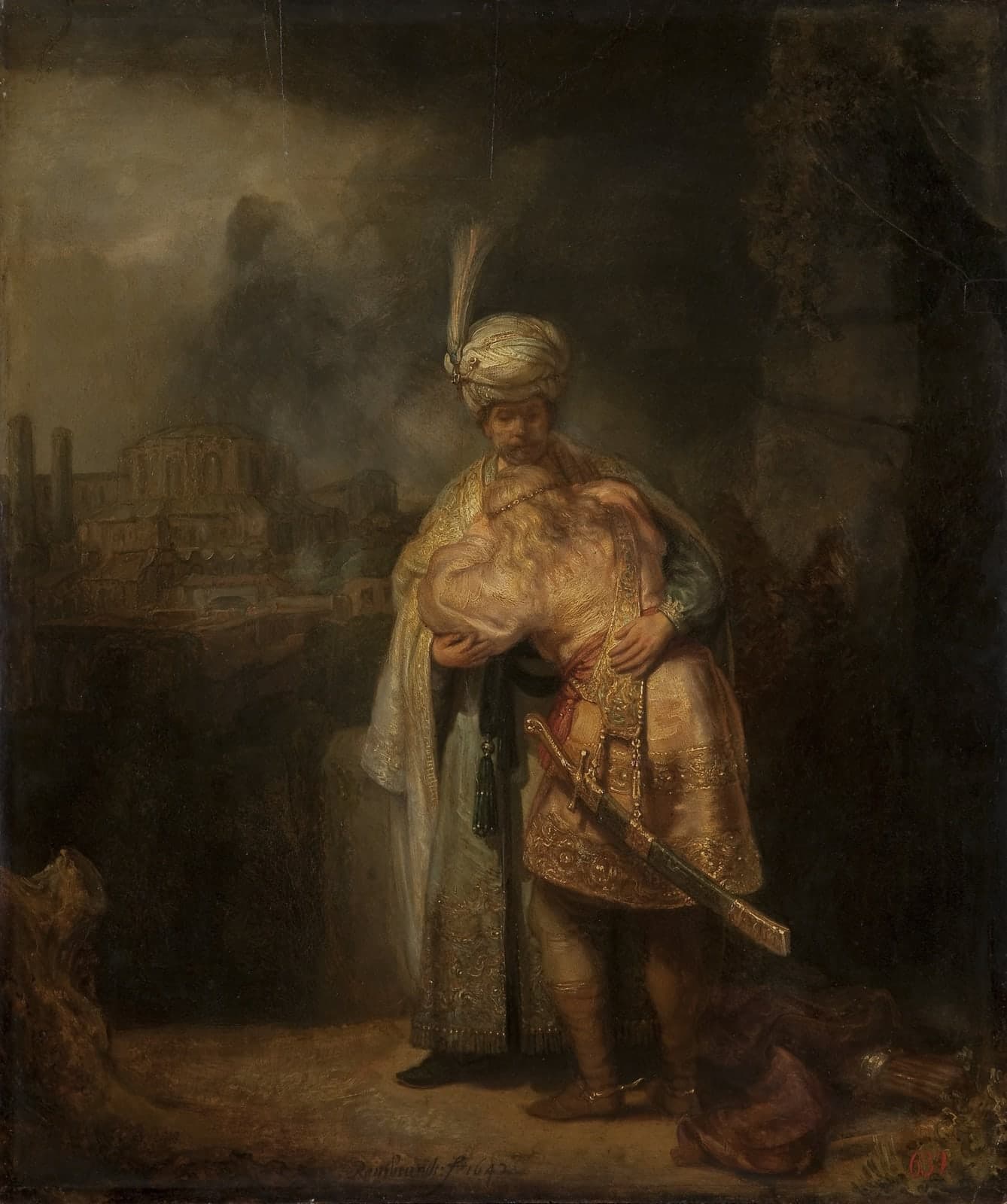 A tall bearded man in a white turban with a plume and a long gold-embroidered robe holds a younger man with long fair hair who weeps against his chest; the younger man wears a short embroidered tunic and a curved sword, a quiver lies on the ground at their feet, and a domed city rises in the dark distance on the left.
