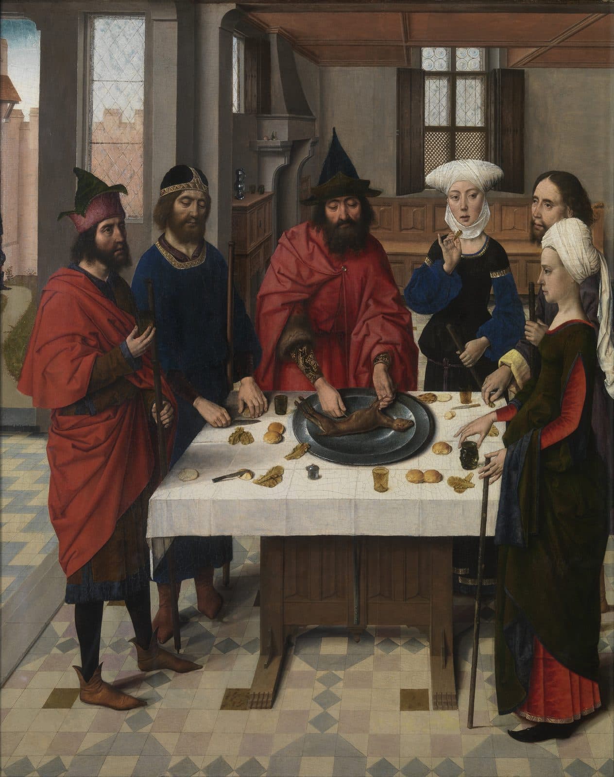 An Israelite household stands around a table eating the roast lamb, staffs in hand, dressed to travel.