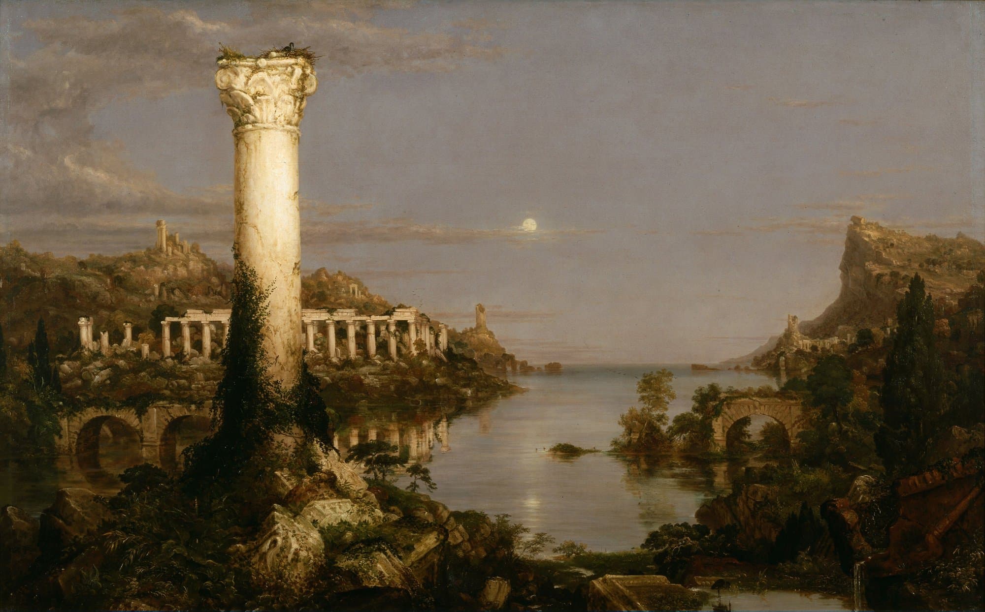 Moonlight falls on the ruins of a great city beside a still harbour: a single tall column stands among broken arches and overgrown walls, with wooded hills and a crag behind.