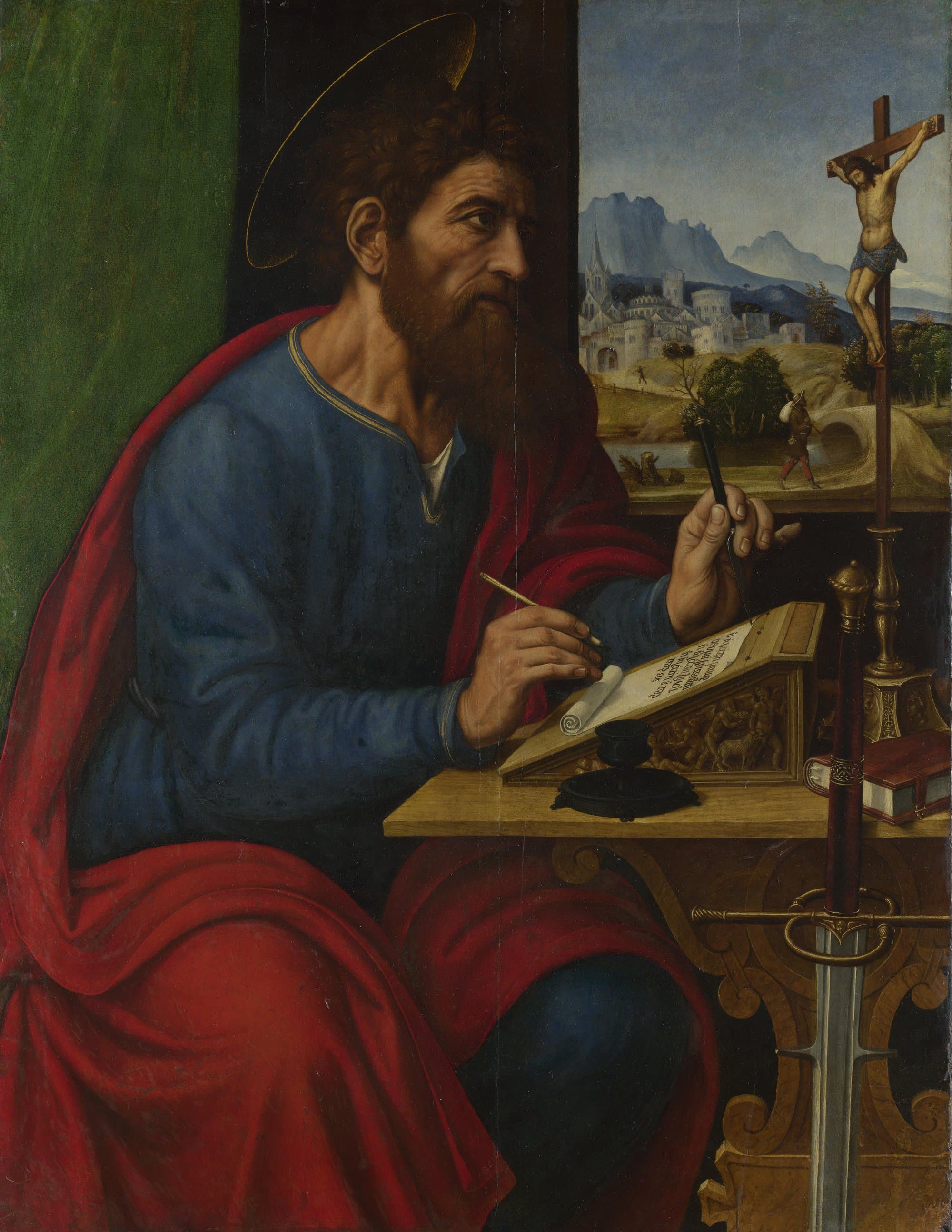 A painting of the apostle Paul, bearded and haloed, in a blue robe and a red cloak, seated at a writing desk with a pen over a scroll, a sword standing beside the desk, a crucifix on the table and a walled town and mountains seen through the window behind him.
