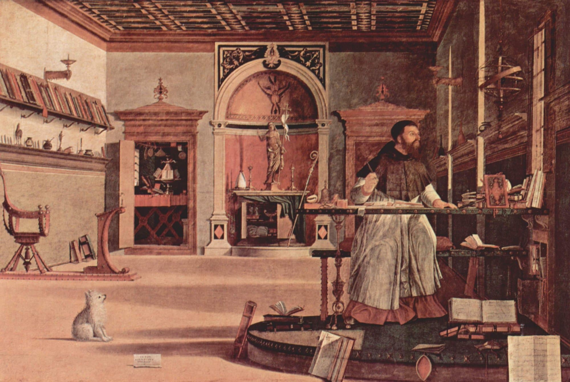A painting of a bearded scholar in a white surplice and dark cape seated at a long desk in a wide study, pen raised, looking up toward light from a window at the right, with books and instruments on shelves, an altar with a statue of the risen Christ in a niche behind him, and a small white dog sitting at the lower left.