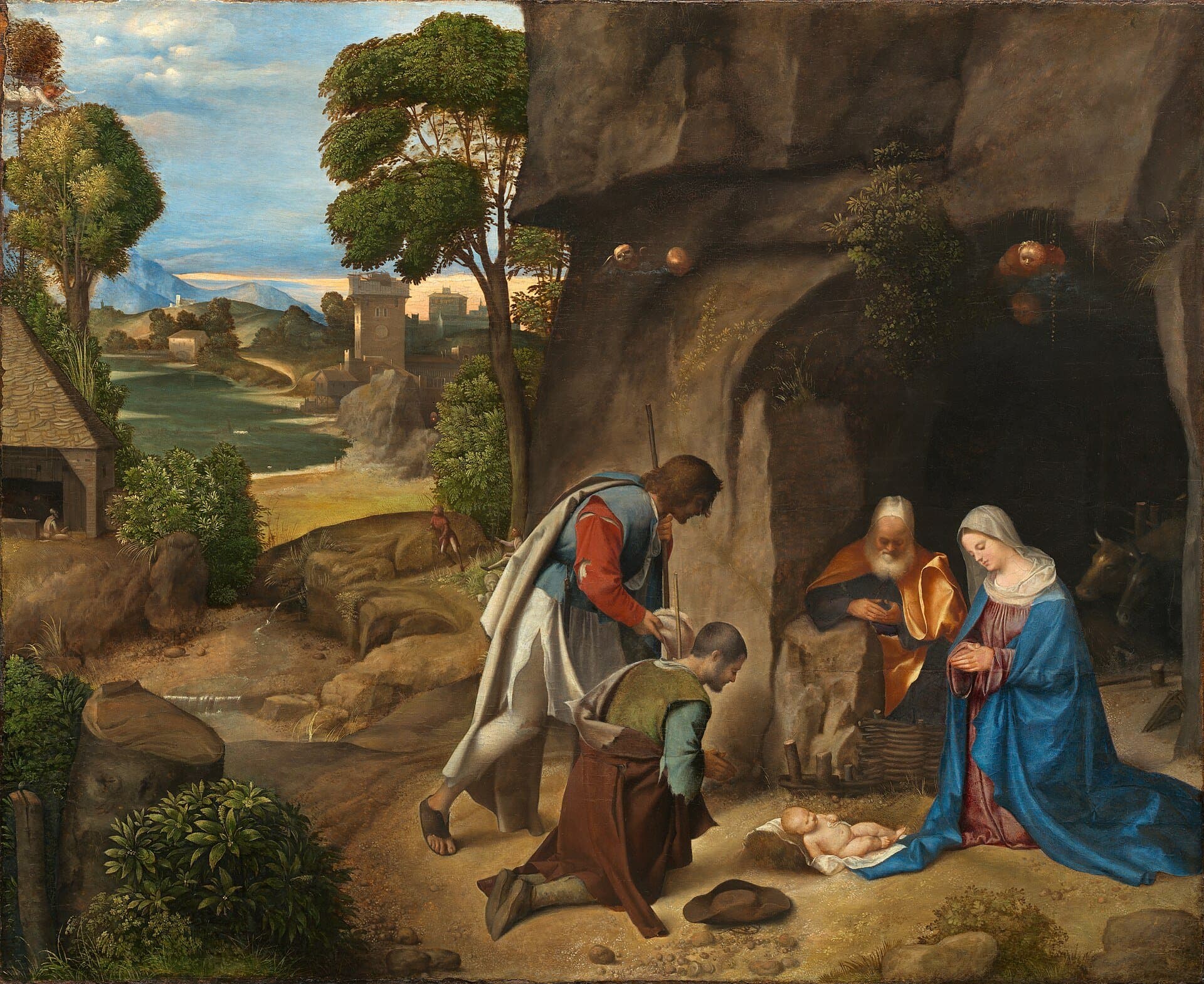 Two shepherds kneel before the newborn Christ, who lies on the ground at the mouth of a dark cave while Mary and Joseph kneel beside Him, and a wide green valley with a river and distant hills opens to the left.