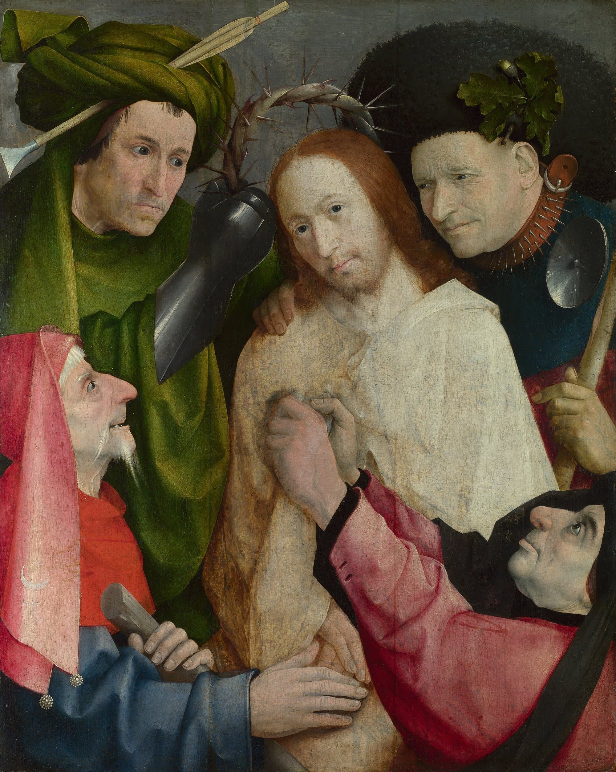 Jesus in a pale robe stands at the centre looking out, while four tormentors crowd around Him, one in a green turban holding a crown of thorns over His head with an armoured hand, one with a spiked collar laying a hand on His shoulder, and two below grasping at His robe.