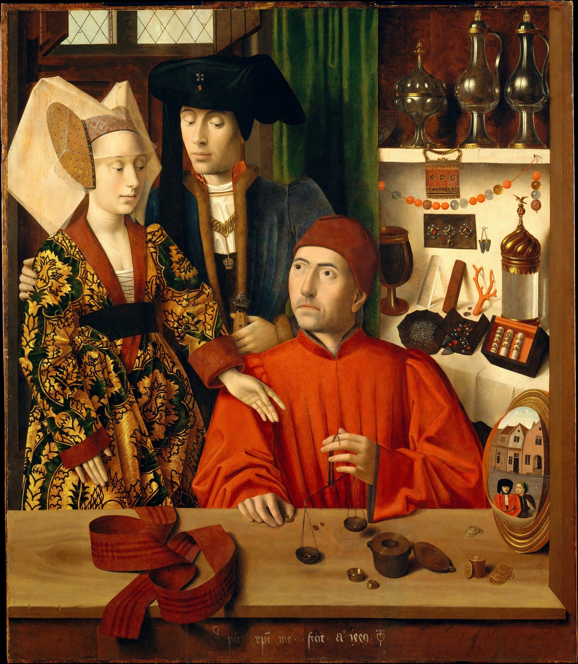 A goldsmith in a red robe and cap sits at his counter weighing a ring on a small balance, while a richly dressed couple stand beside him and shelves of vessels, jewels and coral stand behind.