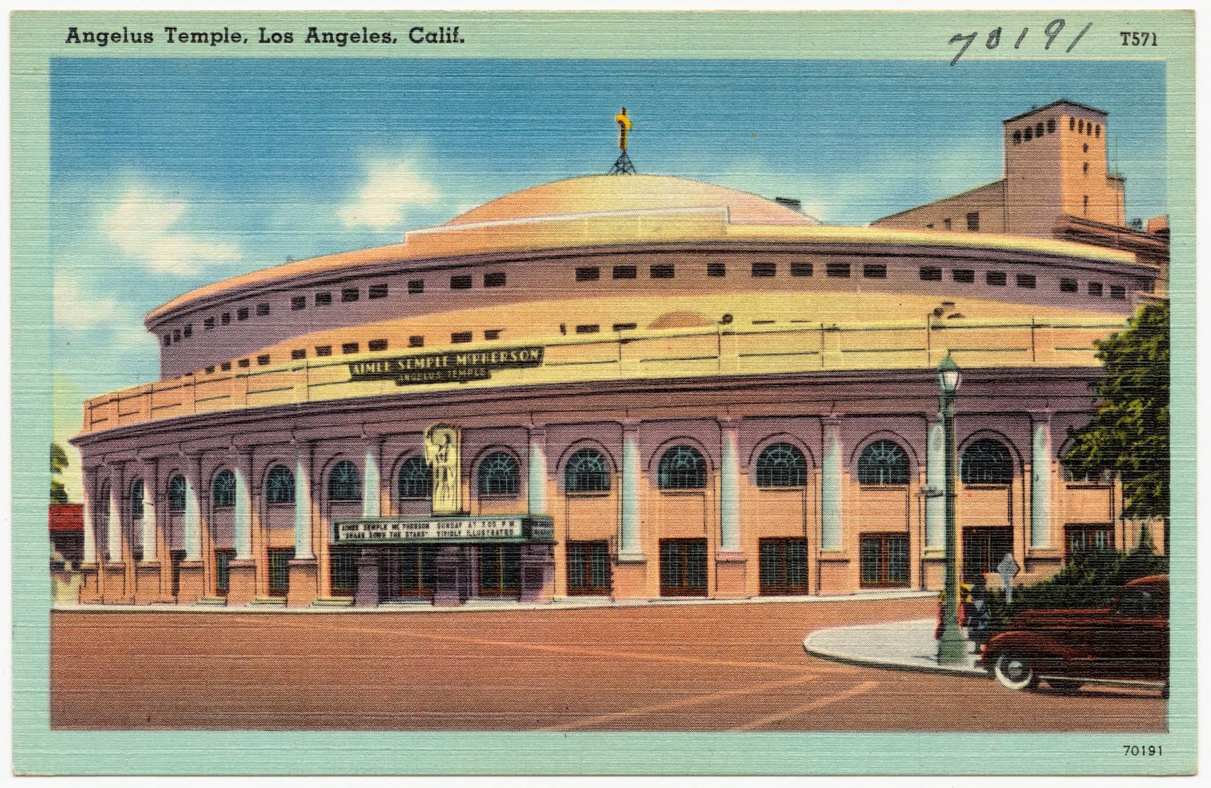 A domed round church with arched windows and her name on its front, on a street corner with a parked car, printed on a postcard.