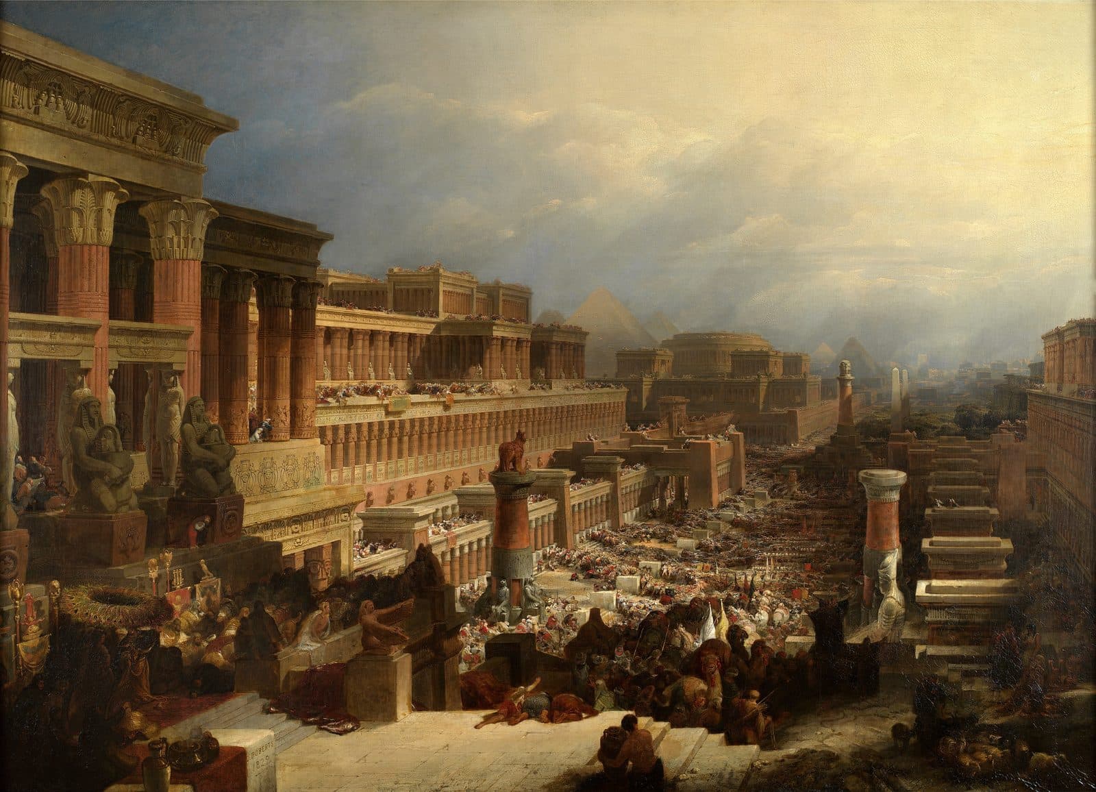 A long column of people, camels and carts streams down a wide avenue between Egyptian temples and colonnades toward distant pyramids, while crowds watch from the roofs and mourners lie on the steps in the foreground