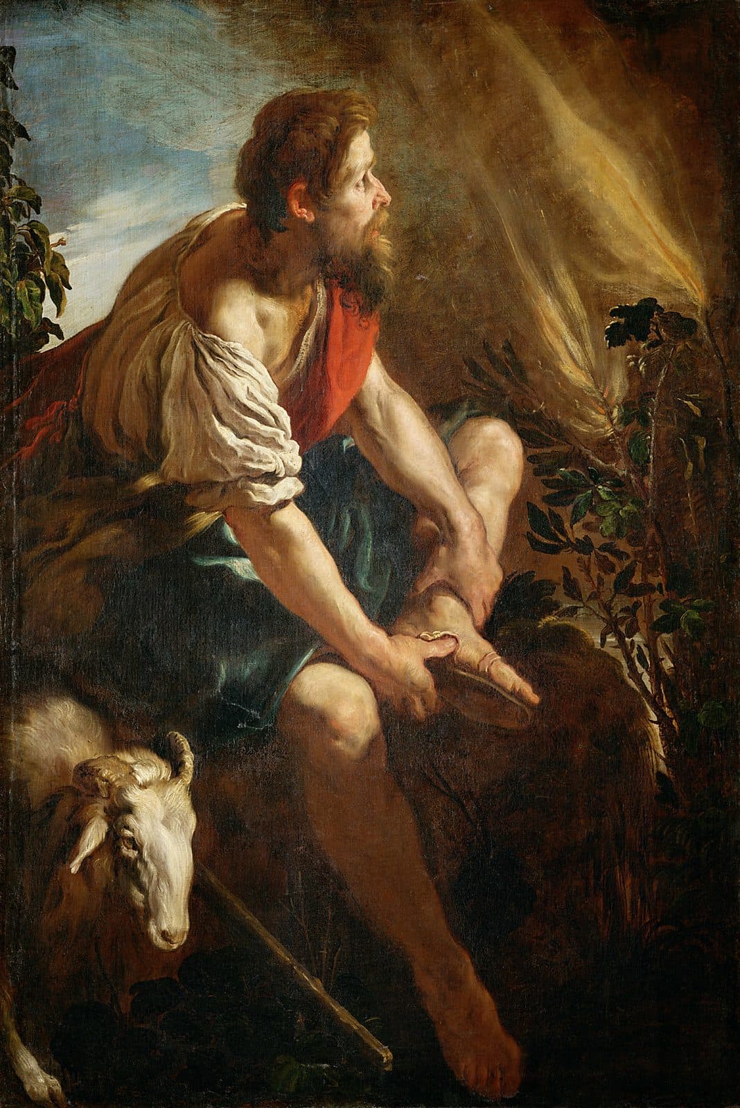 A bearded shepherd in a white shirt and red vest sits on a rock, pulling the sandal from his bare foot and looking up at flames rising from a bush at the right. A ram lies at his side and his staff rests on the ground.