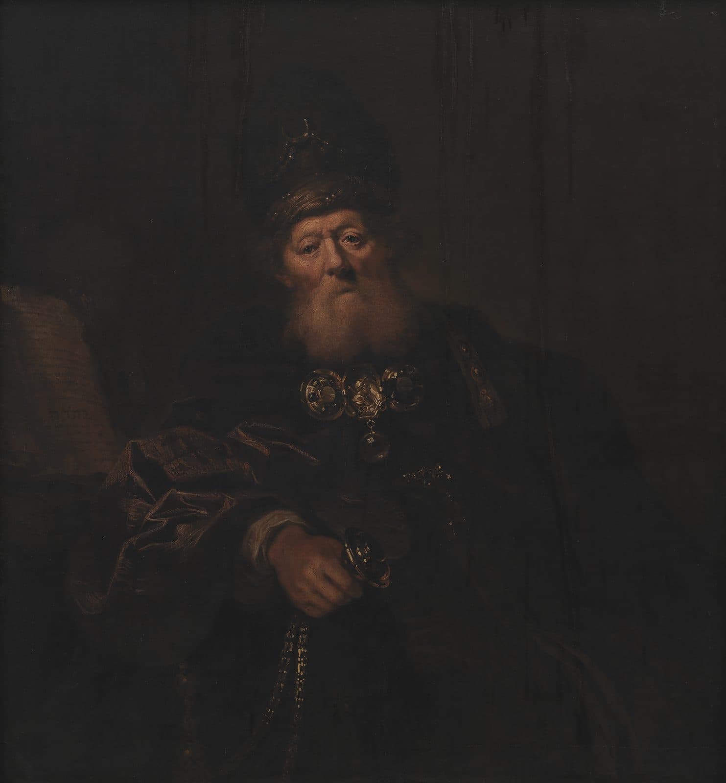 An old bearded man in a jeweled turban and a dark robe sits against a dark ground, a gold breastplate of round settings on his chest and a gold censer in his hand. An open book with Hebrew letters lies at the left.