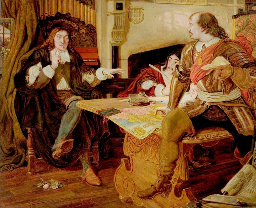 Cromwell in armour sits at a table spread with a map and turns toward a long-haired man in black who speaks with a raised hand, while a third man in red writes.