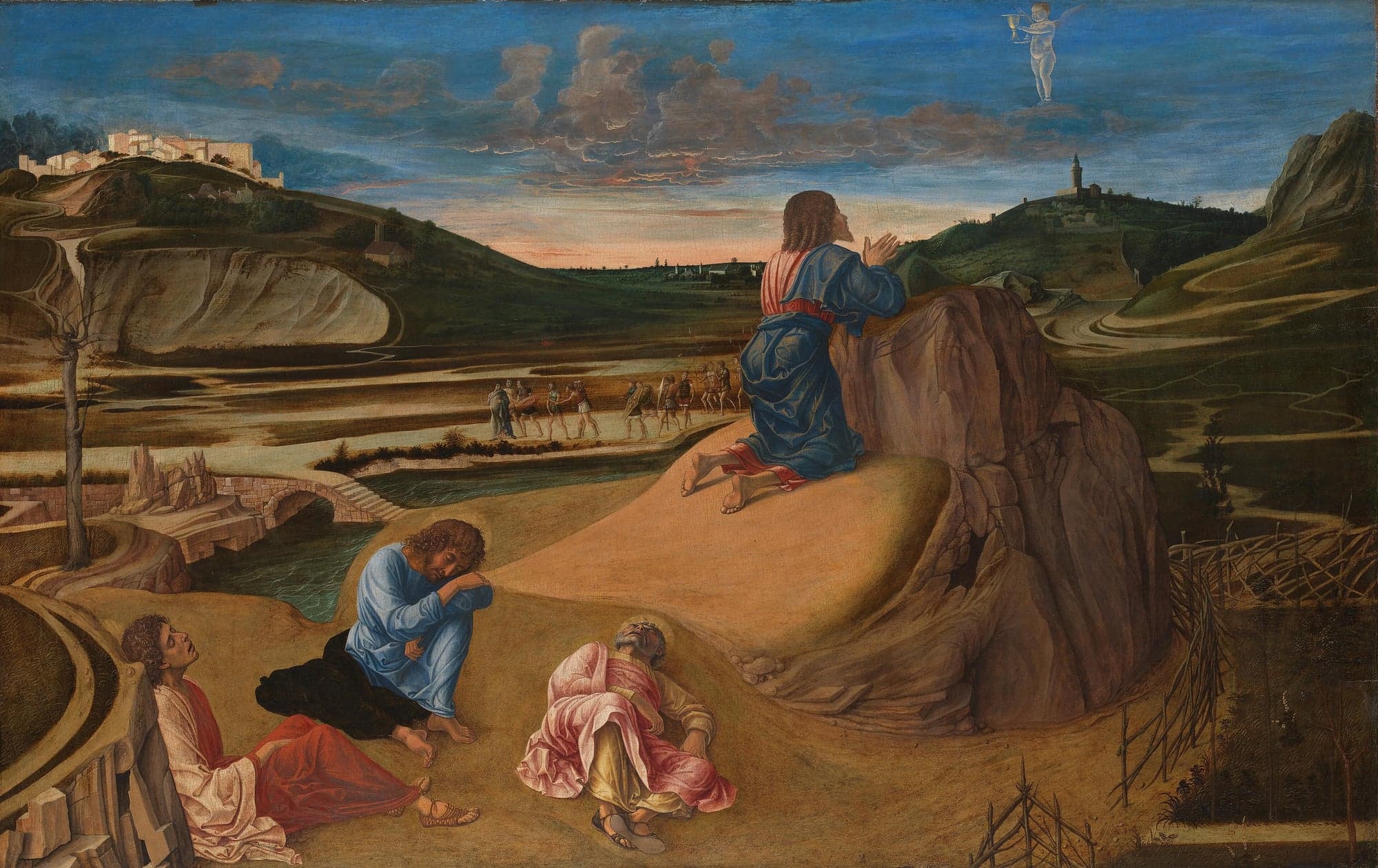Jesus kneels in prayer on a rocky outcrop at dusk while three disciples sleep on the ground below; a small angel holding a cup appears in the sky, and a band of armed men walks along the road in the valley behind.