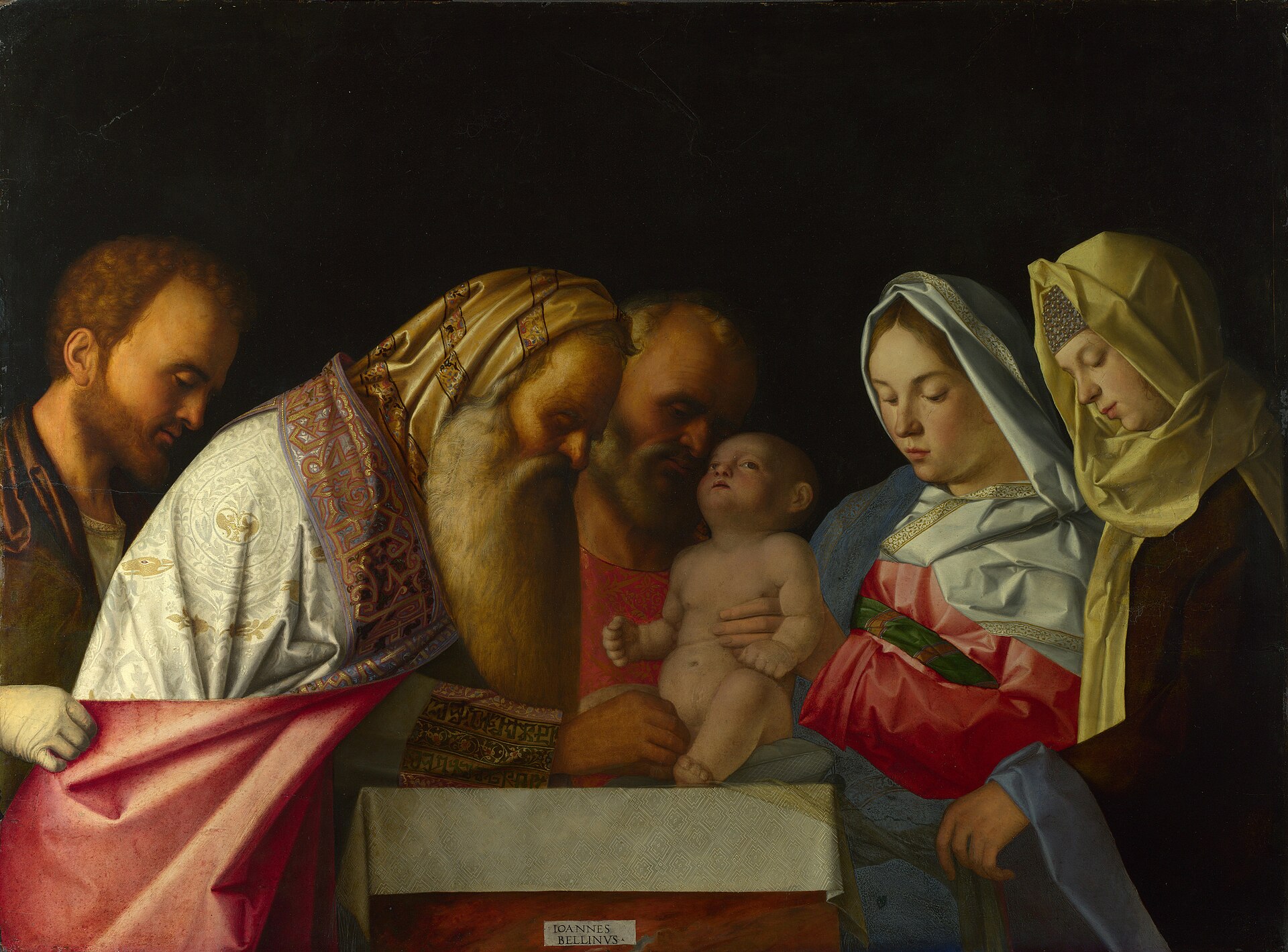 Against a dark ground, an old priest with a long white beard and a striped headcloth bends over a naked infant held up on a white-covered table by a bearded man, while a young man watches at the left and two women in white and gold veils look down at the child from the right.