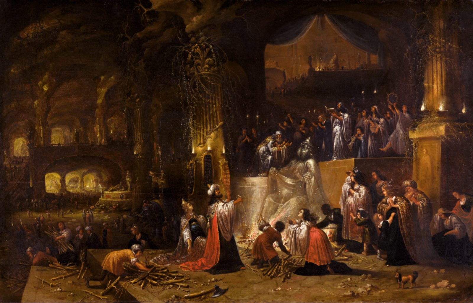 A torchlit cavern of pillars where a crowned king in a red cloak kneels before a fire beneath a seated idol draped in white, a priest lifts a child on the platform above, men carry bundles of wood and women weep at the right.