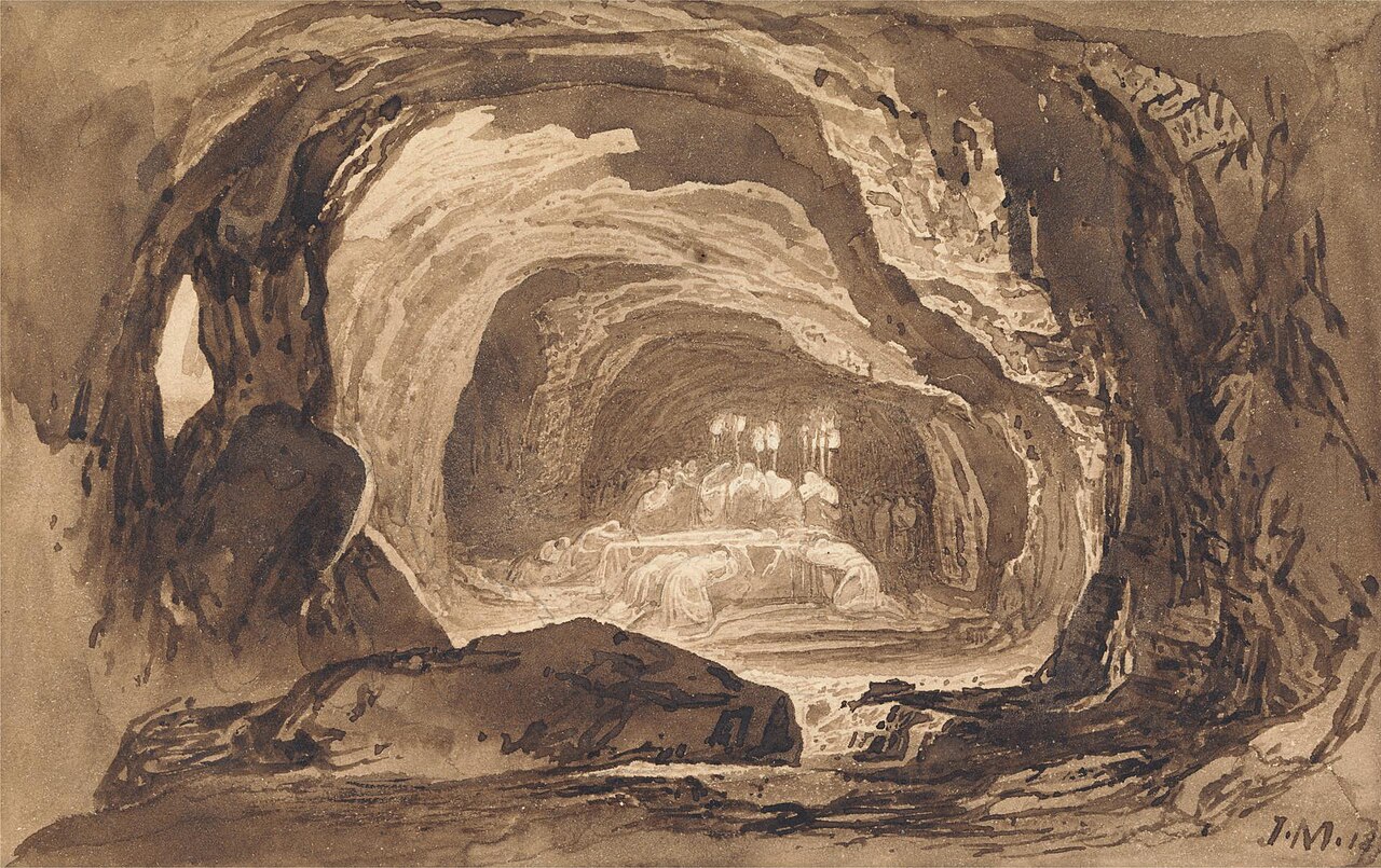 John Martin's brown ink drawing of a great rock cave seen from its mouth, with mourners in pale robes gathered about a bier deep inside it, lit by raised torches, and a large boulder in the foreground