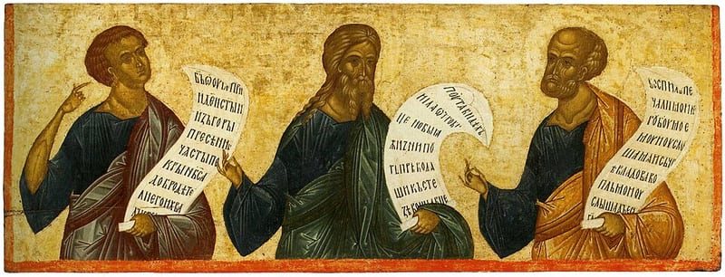 Three prophets in robes stand on a gold ground, each holding an unrolled scroll of Slavonic text; the first points upward, the second holds his scroll low and the third gestures toward his scroll